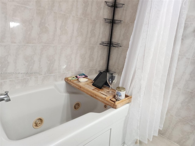 bathroom with tiled shower and a jetted tub