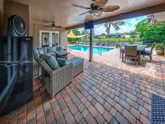 view of patio / terrace with outdoor dining area, french doors, a ceiling fan, fence, and an outdoor living space