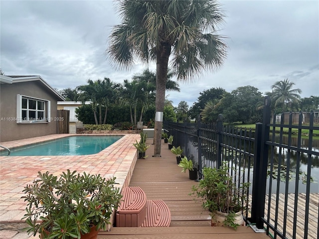 view of swimming pool featuring a patio area, fence, and a fenced in pool