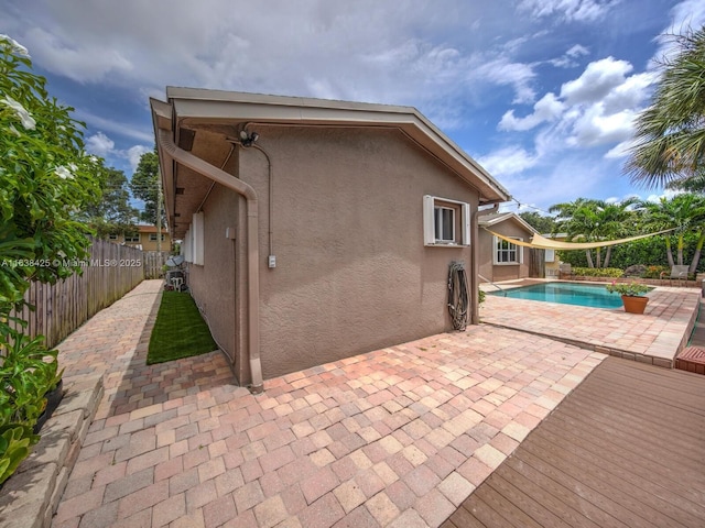 view of pool featuring a patio area, fence, and a fenced in pool