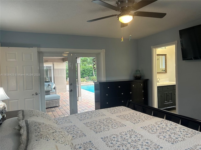 bedroom with french doors, ensuite bathroom, ceiling fan, a sink, and access to outside