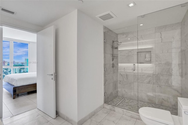 bathroom with toilet, tile patterned floors, and an enclosed shower