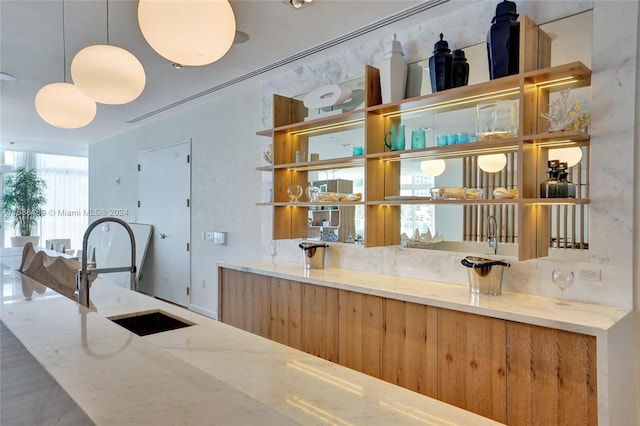 interior space with sink and hanging light fixtures