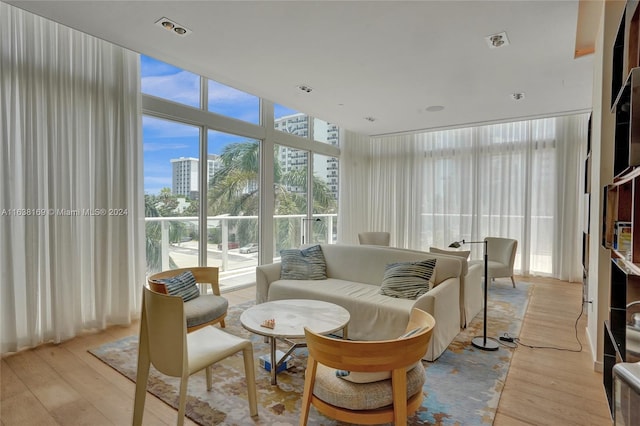 interior space featuring a wall of windows and light hardwood / wood-style flooring