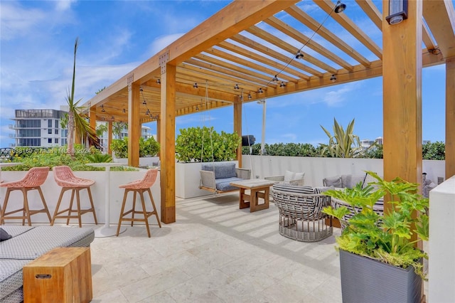 view of patio / terrace with a pergola, a bar, and an outdoor living space with a fire pit