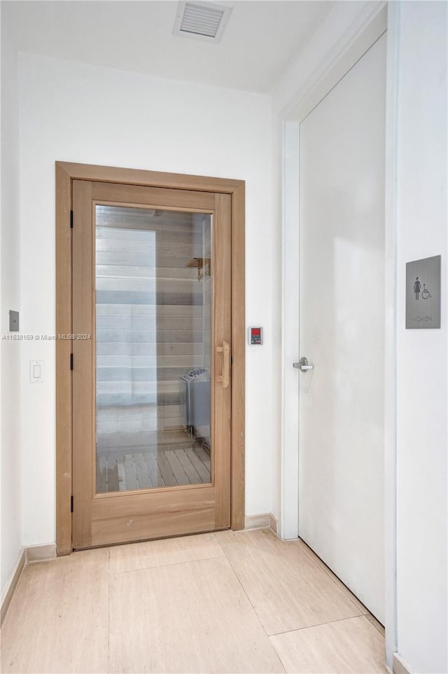 hall with light tile patterned floors