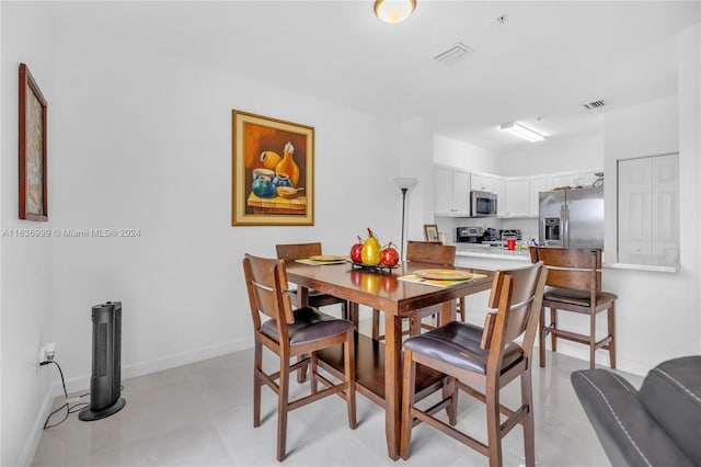 dining space featuring light tile patterned floors