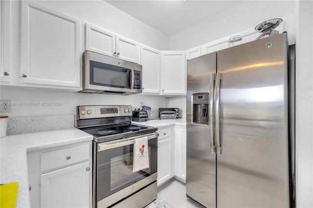 kitchen with white cabinetry and stainless steel appliances