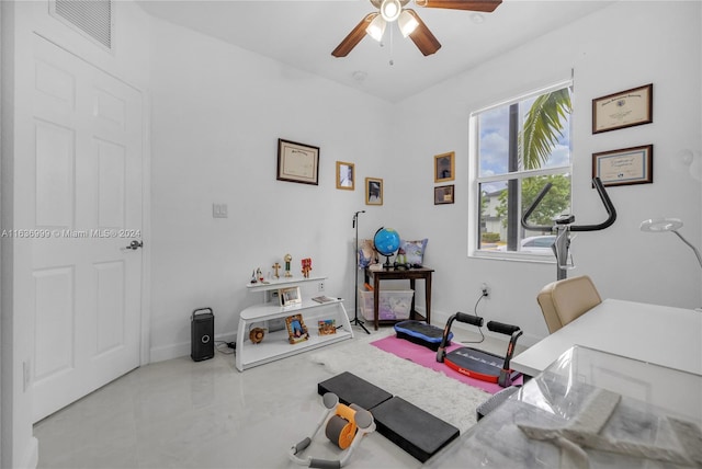 exercise room with tile patterned flooring and ceiling fan