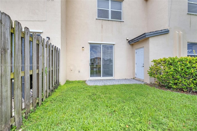 rear view of property with a lawn