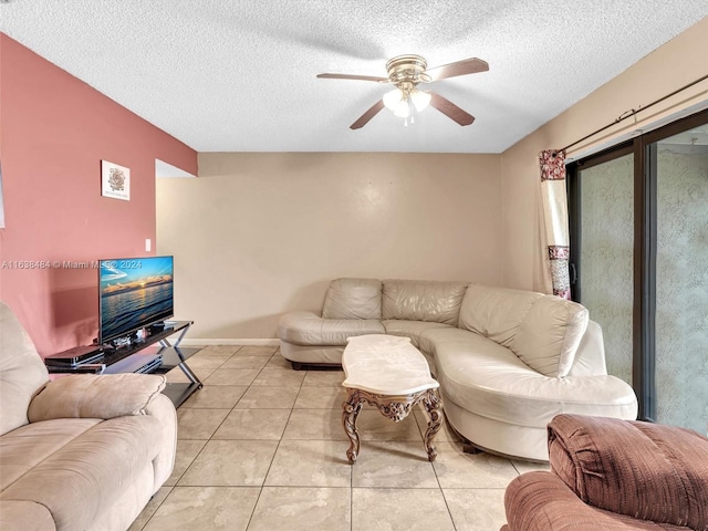 tiled living room with ceiling fan and a textured ceiling