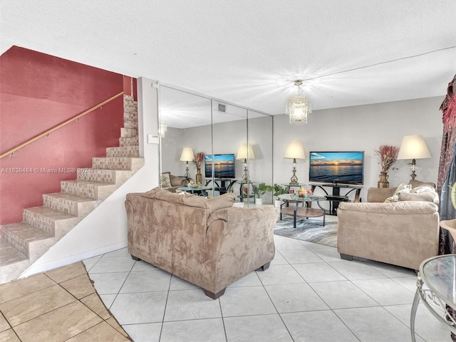 tiled living room featuring a textured ceiling