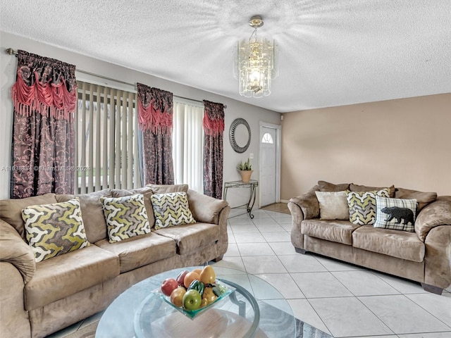 living room featuring a chandelier, light tile patterned floors, and a textured ceiling