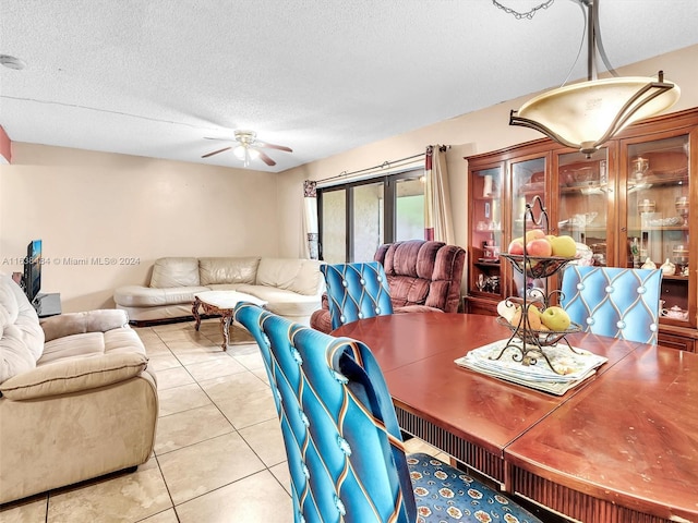 dining space with ceiling fan, french doors, light tile patterned flooring, and a textured ceiling