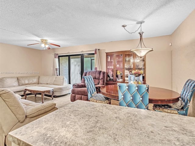 living room featuring french doors, a textured ceiling, and ceiling fan