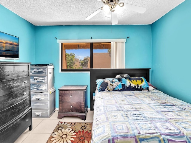 tiled bedroom with ceiling fan and a textured ceiling