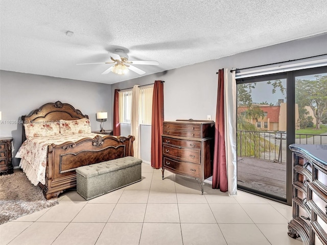 tiled bedroom with a textured ceiling, access to outside, multiple windows, and ceiling fan