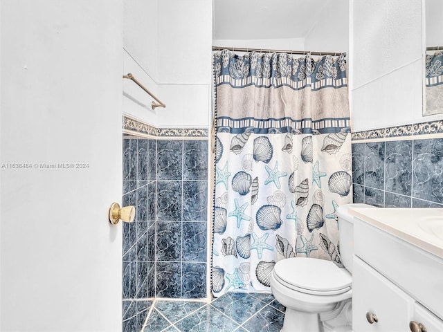 bathroom with a shower with shower curtain, vanity, toilet, and tile walls