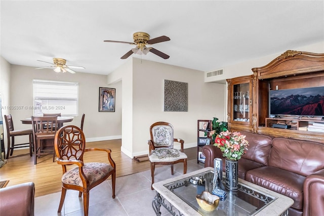 living room featuring light hardwood / wood-style flooring and ceiling fan