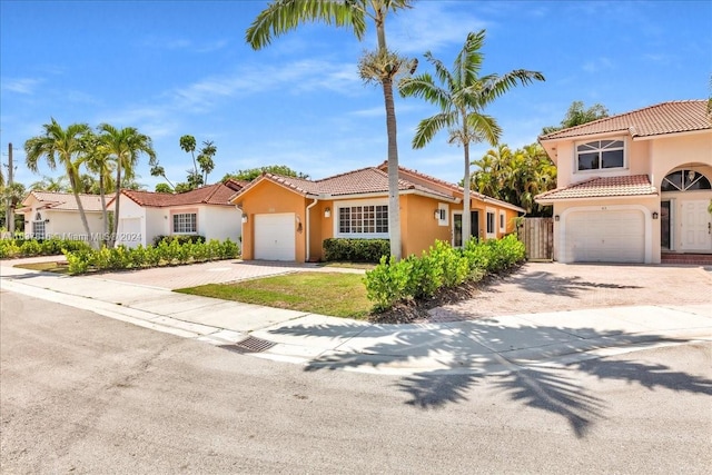 mediterranean / spanish-style home with a garage