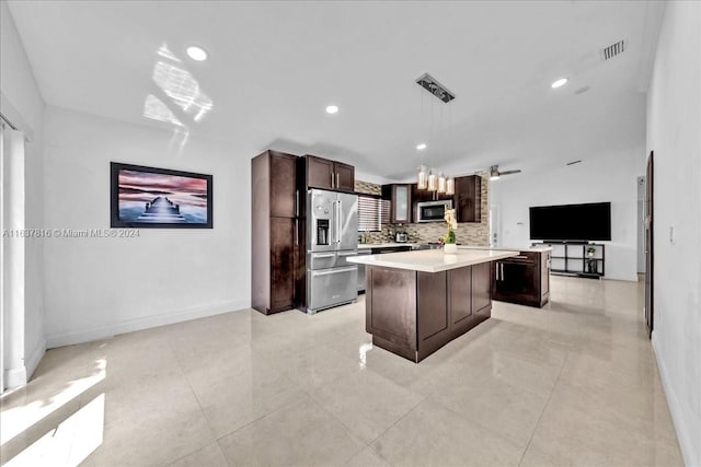 kitchen featuring dark brown cabinets, hanging light fixtures, backsplash, stainless steel appliances, and a kitchen island