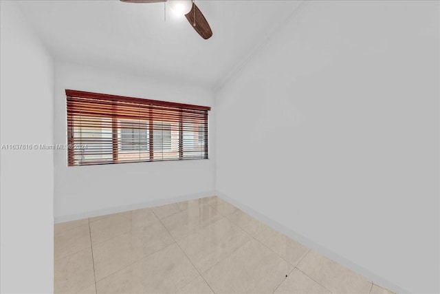 spare room featuring ceiling fan and light tile patterned flooring