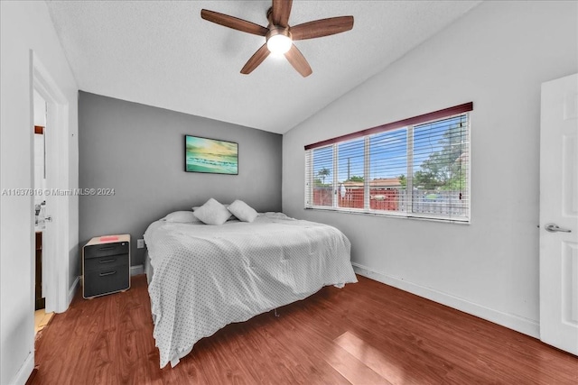 bedroom featuring hardwood / wood-style floors, lofted ceiling, and ceiling fan