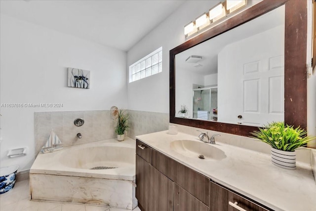 bathroom with tile patterned floors, vanity, and a washtub