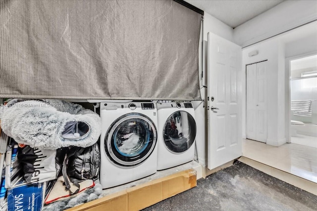 washroom featuring tile patterned floors and washer and clothes dryer