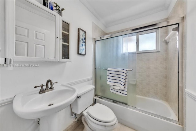 full bathroom with enclosed tub / shower combo, crown molding, sink, and toilet