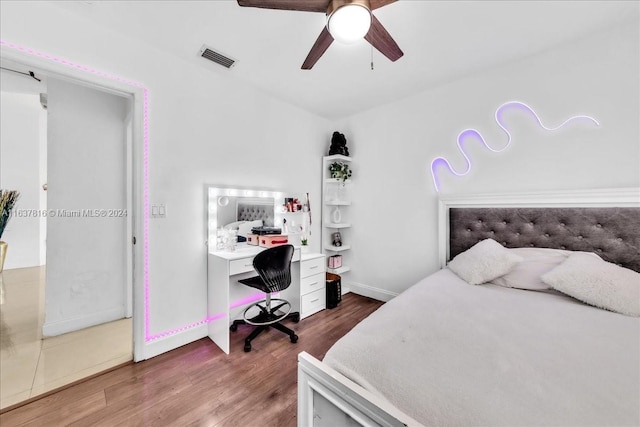 bedroom with ceiling fan and hardwood / wood-style floors