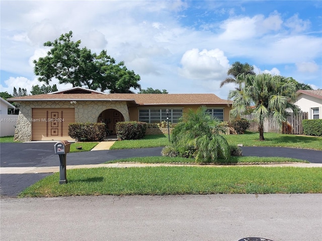 single story home with a front yard