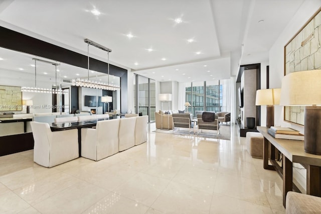 living room featuring a wall of windows and light tile patterned floors