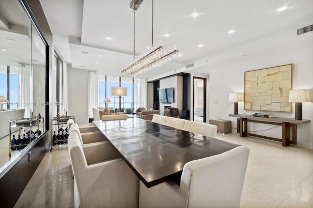 dining room featuring plenty of natural light, light tile patterned floors, and expansive windows