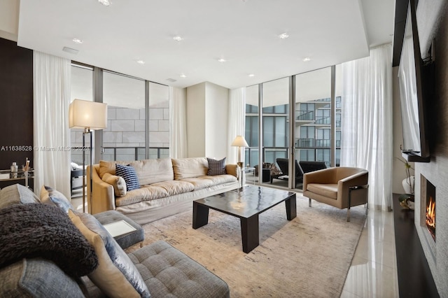 tiled living room featuring a wall of windows