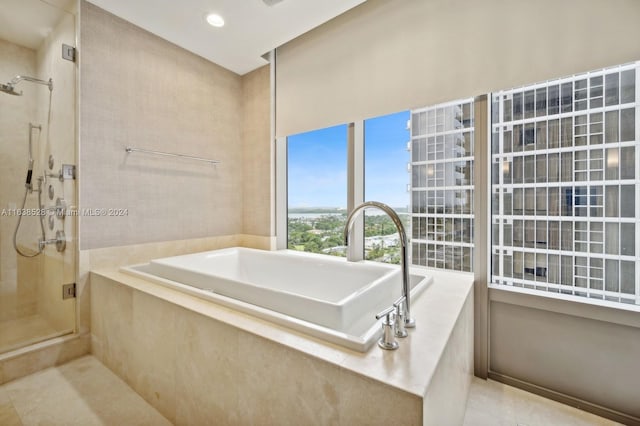 bathroom featuring tile patterned floors and independent shower and bath