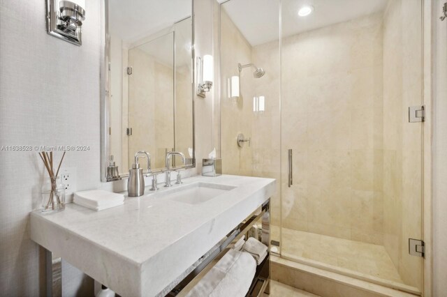 bathroom featuring vanity and an enclosed shower