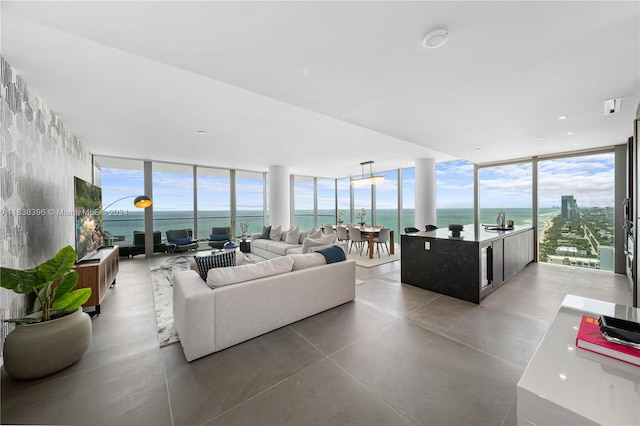 living room featuring a water view, plenty of natural light, and expansive windows