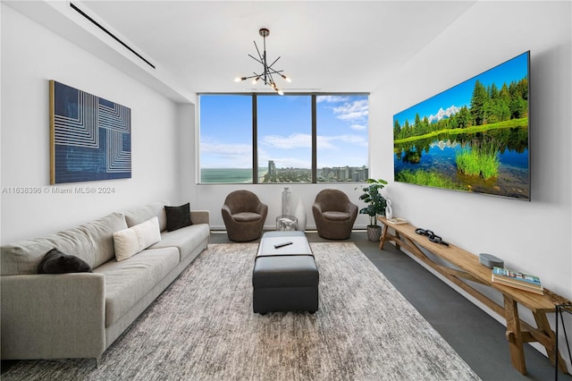 living room with a notable chandelier and concrete flooring