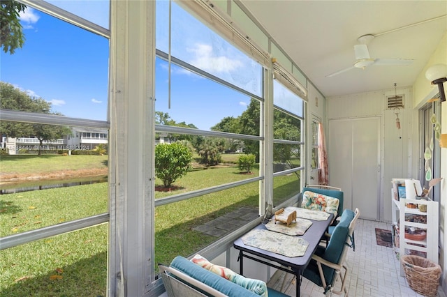 sunroom / solarium with ceiling fan and a healthy amount of sunlight