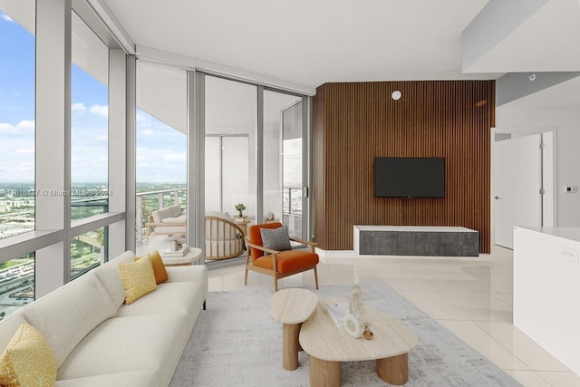 tiled living room featuring wood walls and a wall of windows