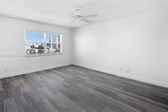 unfurnished room featuring ceiling fan, dark hardwood / wood-style floors, and a textured ceiling