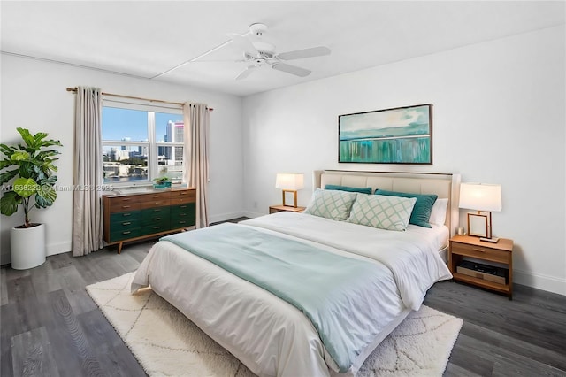 bedroom with dark hardwood / wood-style floors and ceiling fan