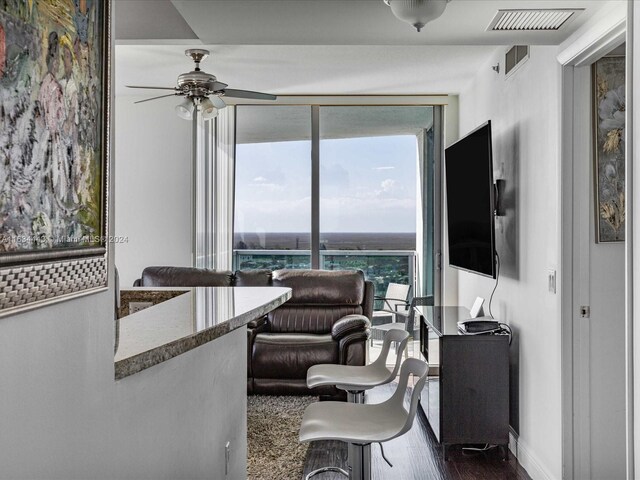 living room with ceiling fan and wood-type flooring