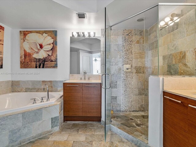 bathroom with tile patterned floors, vanity, and independent shower and bath