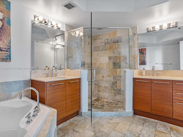 bathroom featuring dual vanity, tile patterned floors, and shower with separate bathtub