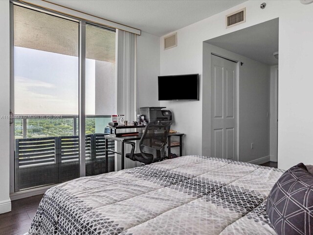 bedroom featuring access to exterior, hardwood / wood-style floors, and a closet