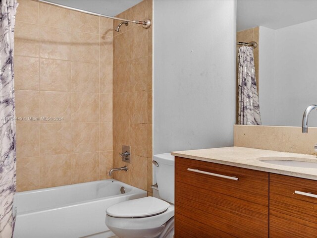 full bathroom featuring shower / bathtub combination with curtain, toilet, and vanity