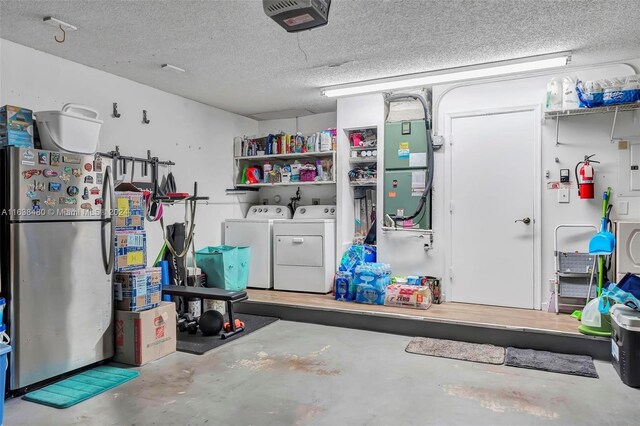 garage with stainless steel fridge, a garage door opener, and separate washer and dryer