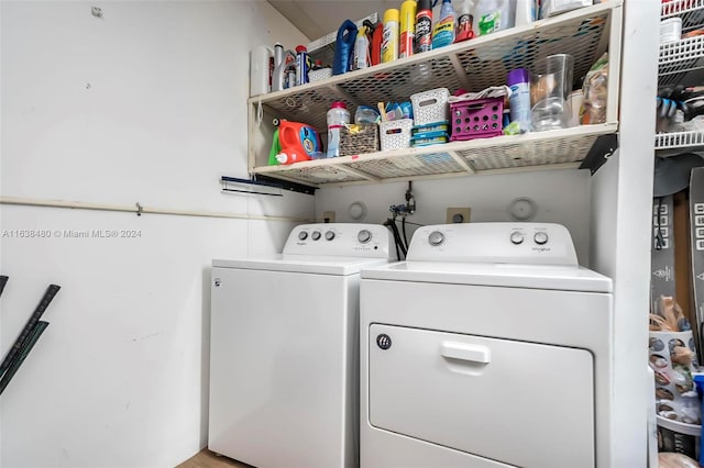 clothes washing area with washer and clothes dryer